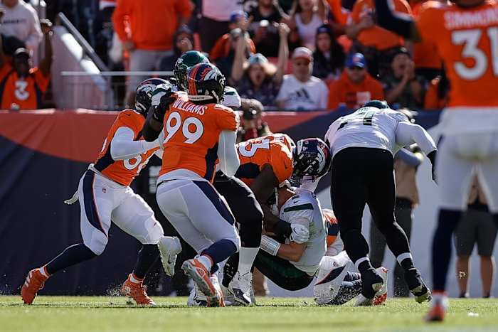 New York Jets quarterback Zach Wilson (2) is sacked by Denver Broncos defensive end Dre'Mont Jones (93) as defensive tackle DeShawn Williams (99) and linebacker Baron Browning (56) defend in the first quarter at Empower Field at Mile High.